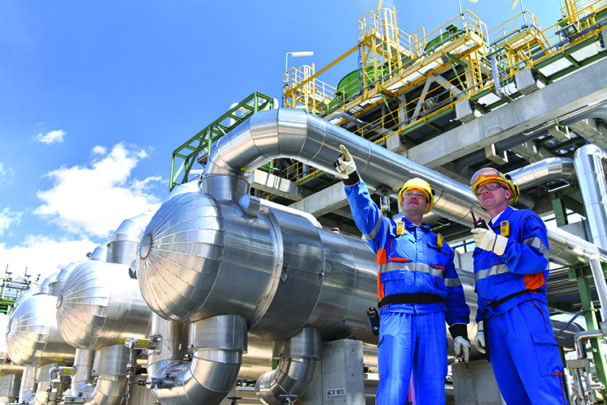 TW0624_industrial workers at oil refinery.jpg