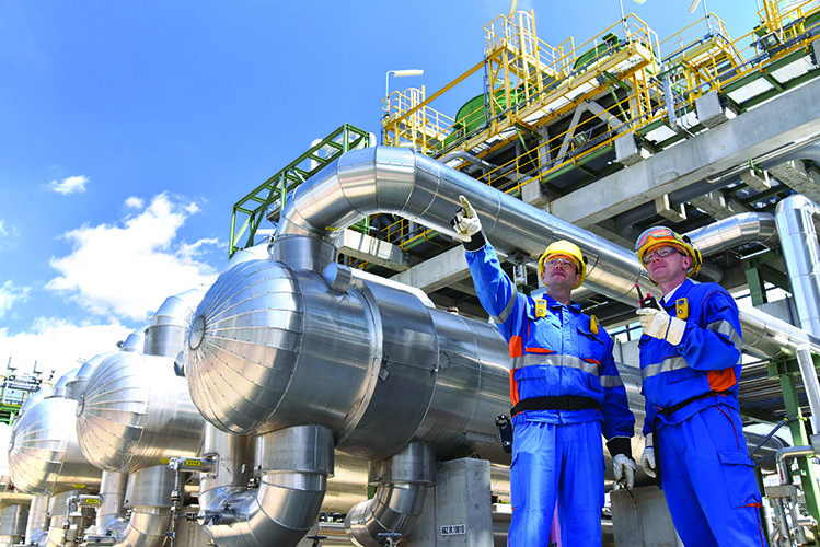 TW0624_industrial workers at oil refinery.jpg